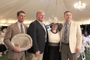 Accepting the award: From left: Dr. John Reynolds and Jay Reynolds, sons of Reuben and Oline Reynolds, Haley Lane, granddaughter of Bill J. Jones, and Memorial Hospital and Manor CEO Billy Walker smile at Derby Night.