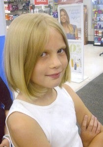 Raegan Moore cut off 13 inches of her long, blonde hair to donate to other sick children.