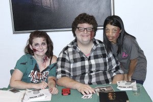 BSC students and zombies, Allie Brock, Grae Cook and Jayme Leigh Cooper welcome guests to the zombie party on Friday evening.