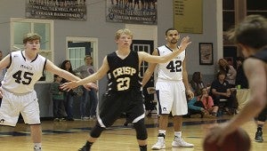 Photo Submitted solid defense: Jared Duke (45) and Nate Walton (42) work hard to defend a Crisp Academy player during the Cougars’ game against the Wildcats last Friday.