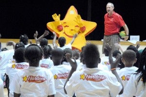 Greg Manning and the Hardee’s mascot pump up the crowd. 